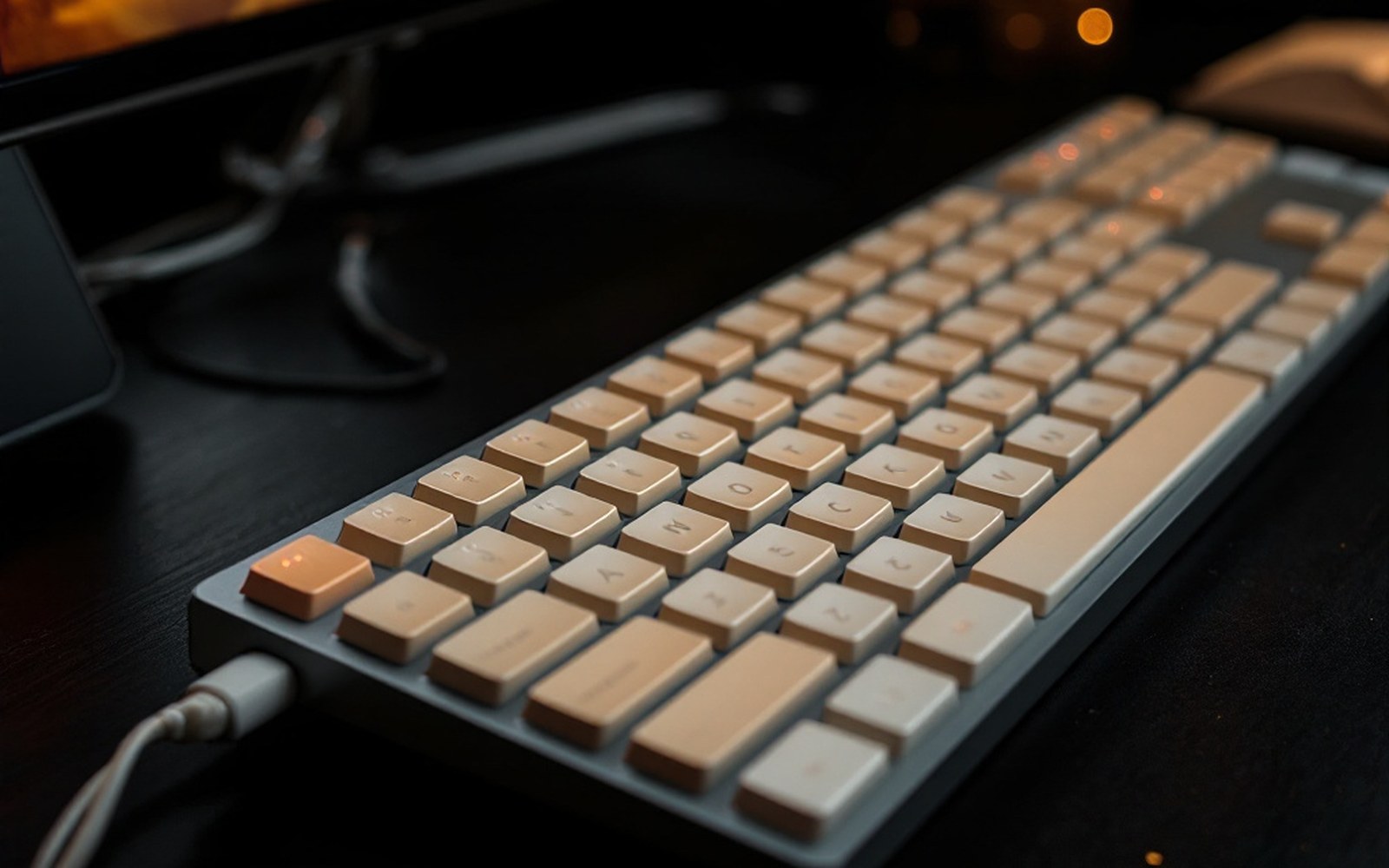 A beige keyboard under one hard light, black surround